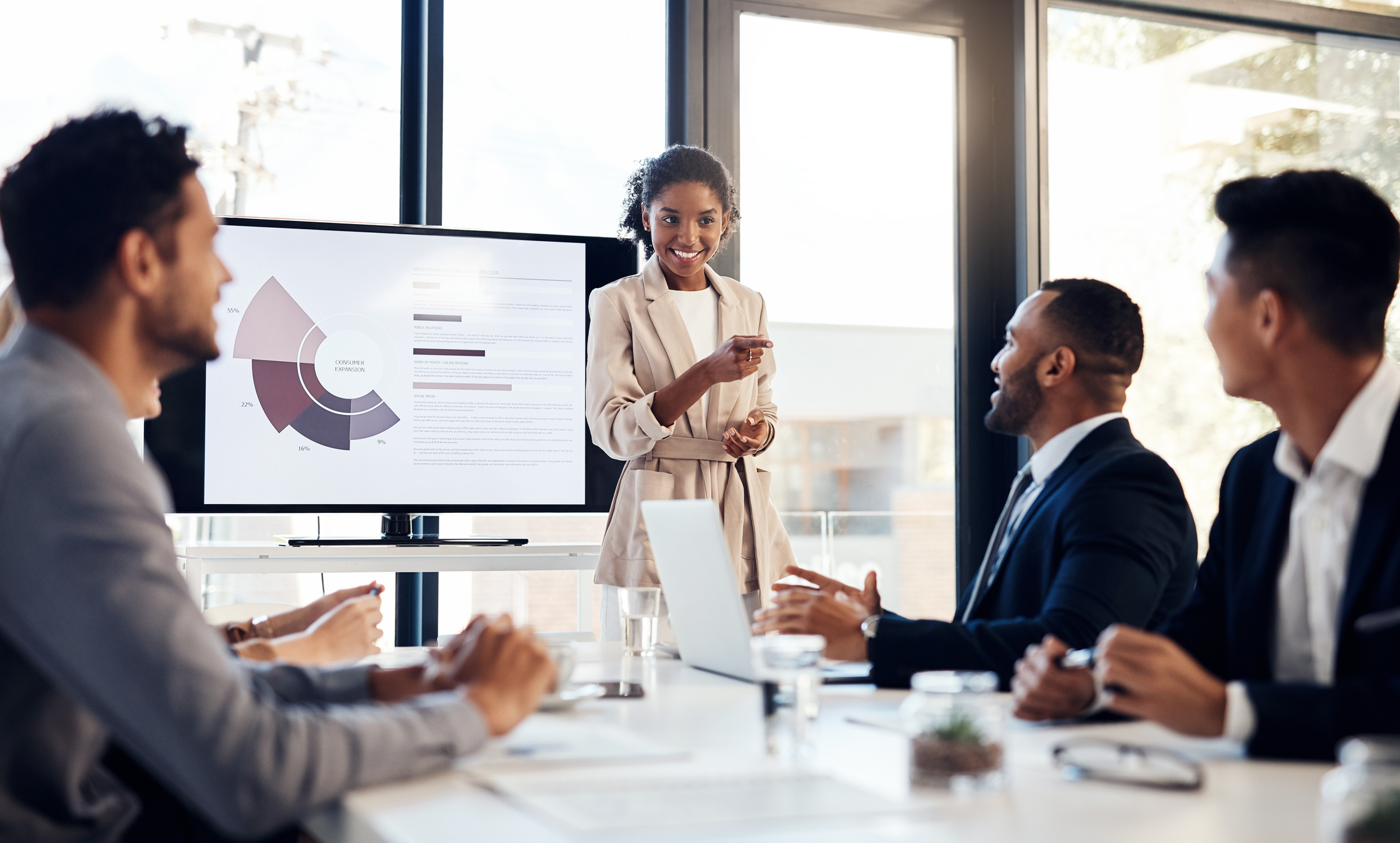 Shot of a young businesswoman delivering a presentation to her colleagues in the boardroom of a modern office